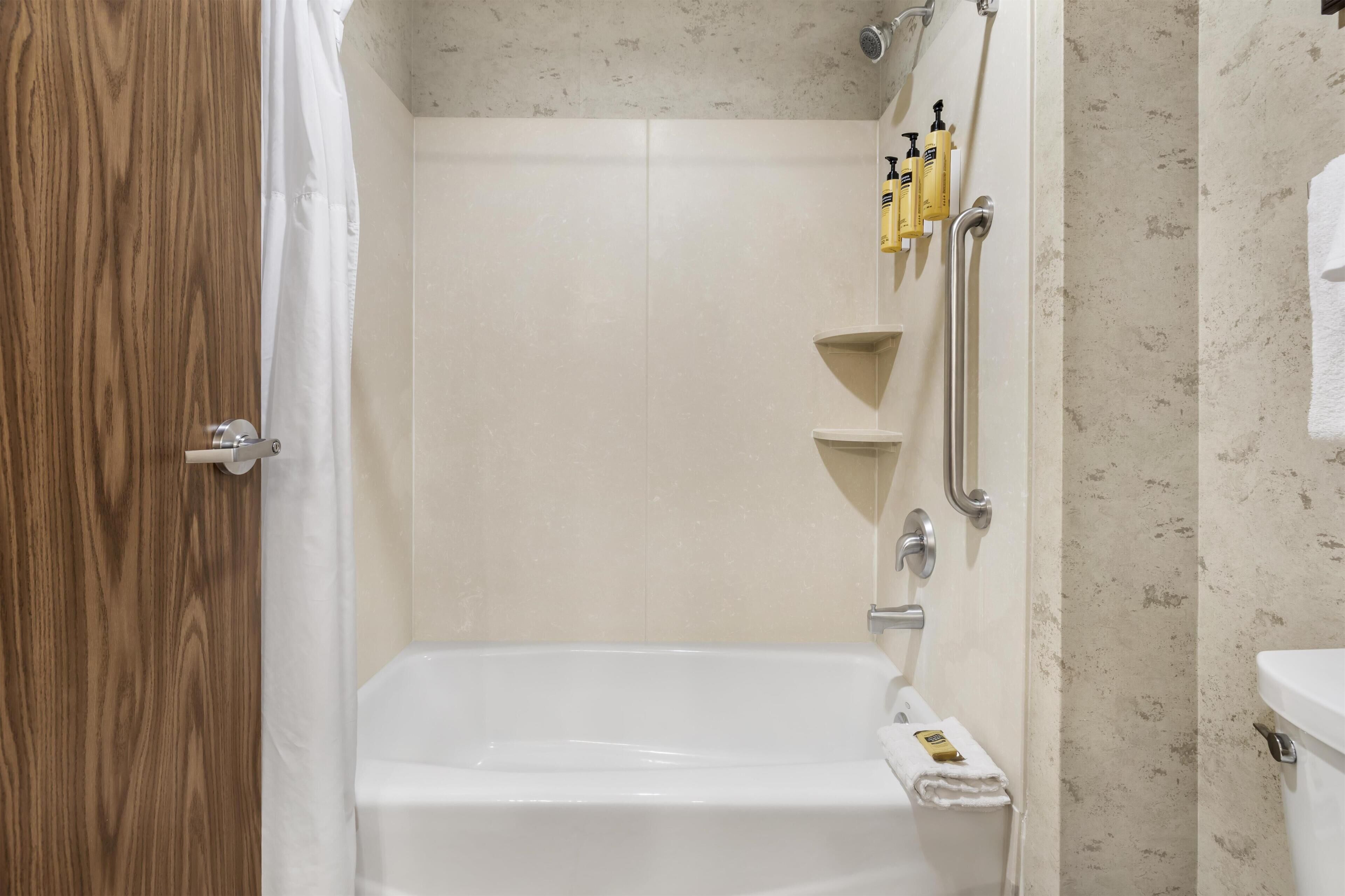A bathroom with a bathtub, a shower, and a toilet.