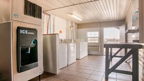 A kitchen with an ice dispenser, a sink, and a window. - Rodeway Inn Pauls Valley (Pauls Valley)