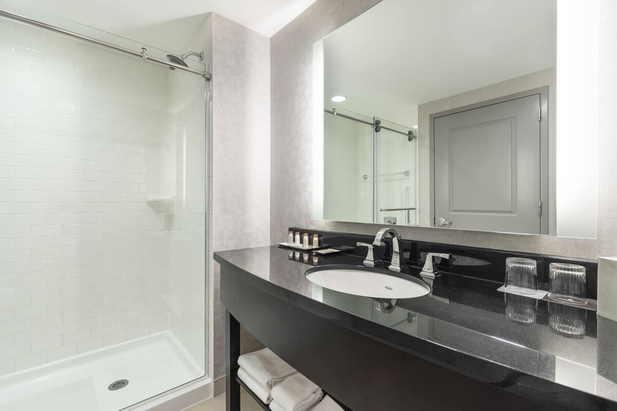 combined shower/bathtub, designer toiletries, hair dryer, bathrobes