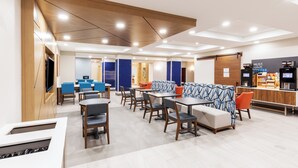 A modern hotel lobby with a seating area, a coffee bar, and a TV screen. - Holiday Inn Express Hotel & Suites Dumas by IHG (Dumas)