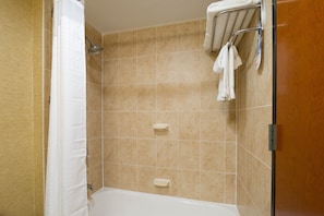 A bathroom with a shower, a bathtub, and a towel rack.
