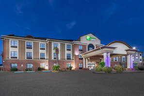 A large, multi-story hotel with a prominent 'Holiday Inn Express' sign, featuring a brick facade, multiple windows, and a covered entrance area. - Holiday Inn Express Hotel & Suites VIDOR SOUTH by IHG (Vidor)