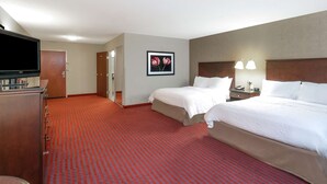 A hotel room with two beds, a TV, a desk, and a framed picture on the wall. - Hampton Inn Richmond Airport (Sandston)