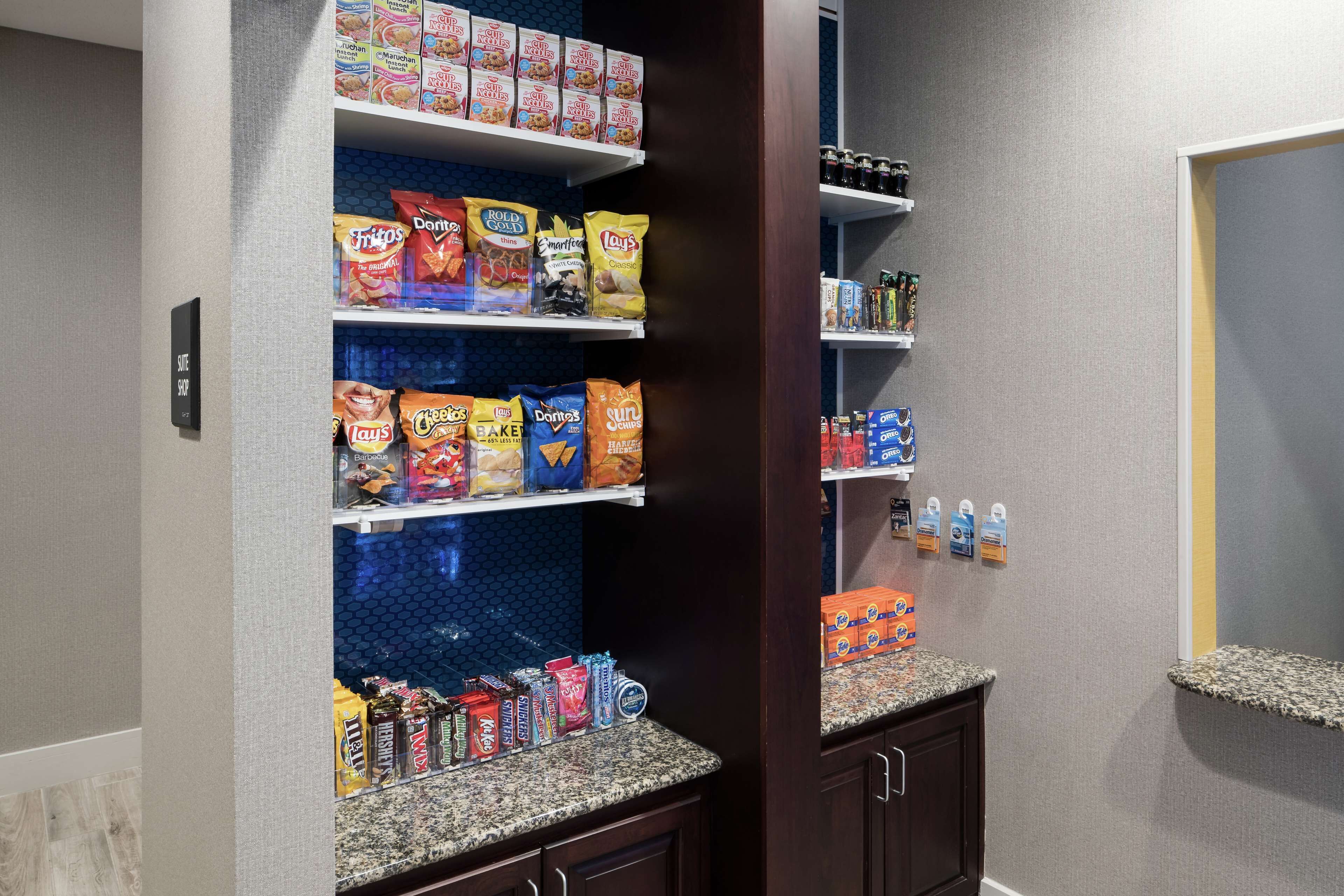A snack bar with shelves stocked with various chips and snacks.