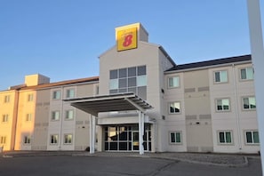 A hotel with a prominent 'Sypes 8' sign, a covered entrance, and multiple windows. - Super 8 by Wyndham Estevan (Estevan)