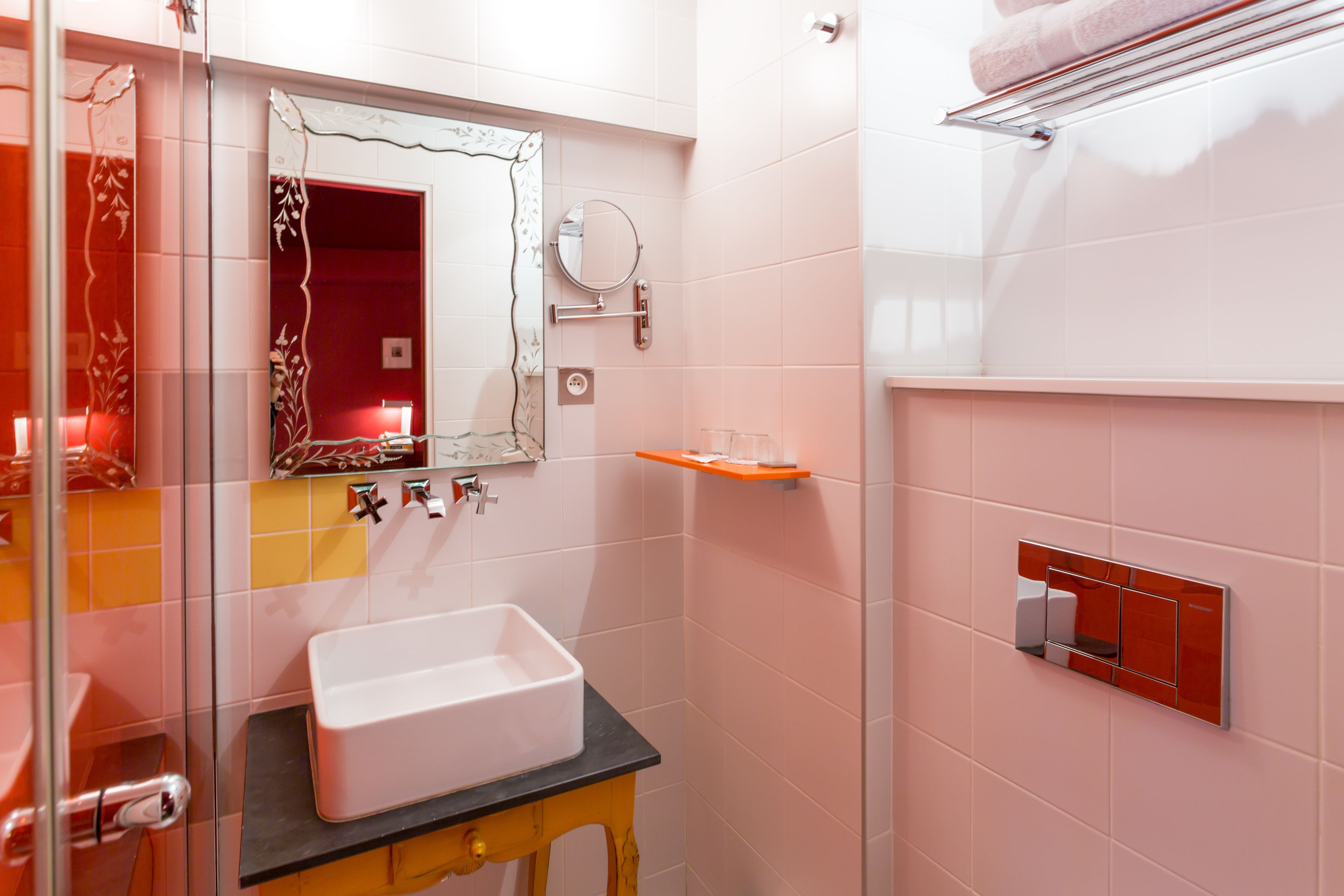 A bathroom with a white sink, a mirror, and a towel rack.