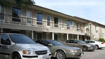 A row of single-story buildings with multiple windows and balconies.