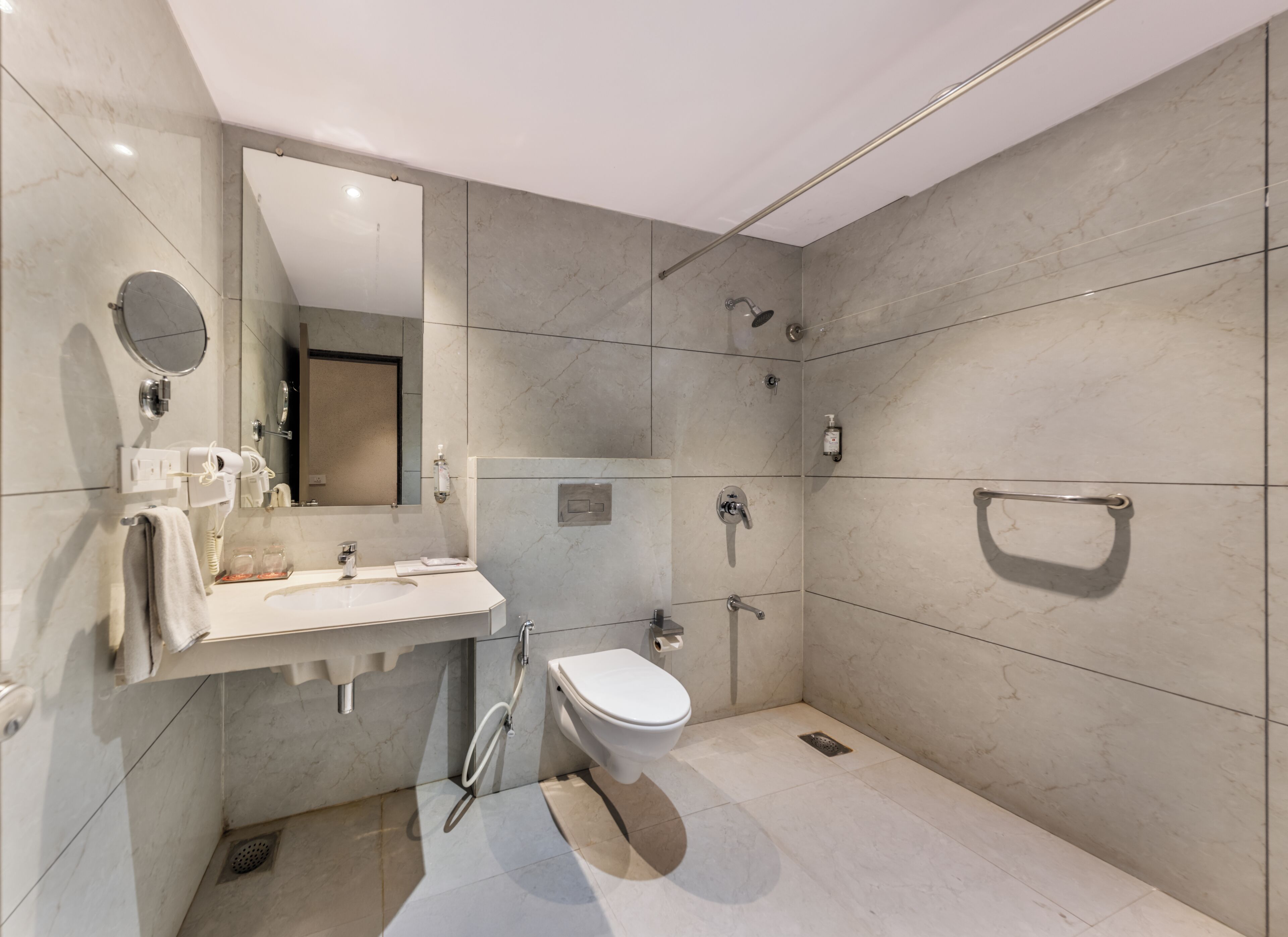 A modern bathroom with a sink, toilet, and shower.