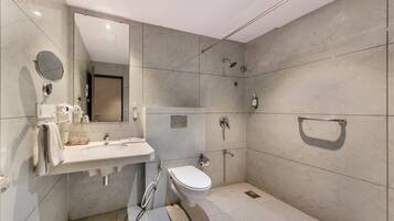 A modern bathroom with a sink, toilet, and shower.