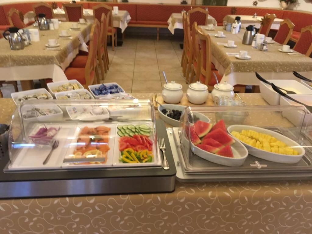 A buffet setup with various food items and condiments.