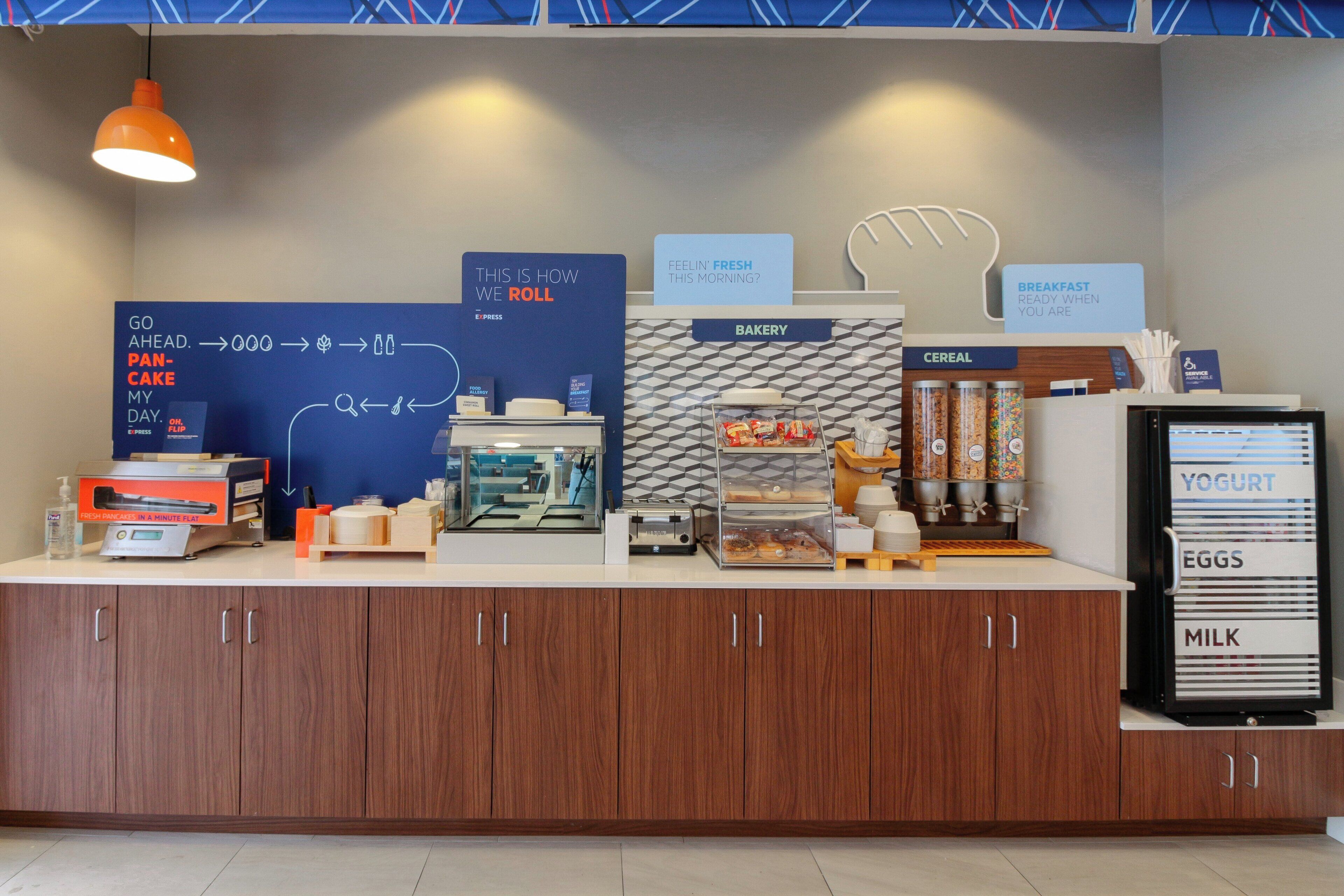 A breakfast counter with a sign indicating the breakfast options available.