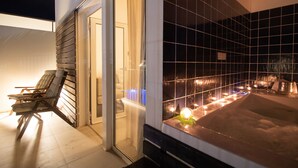 A spa area with a hot tub, wooden chairs, and a tiled wall. - Hotel Dunas de Sal (Sal)