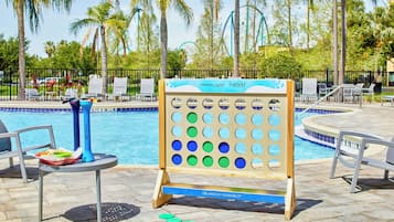 Relax by the pool surrounded by palm trees and enjoy a game or snack with friends and family.