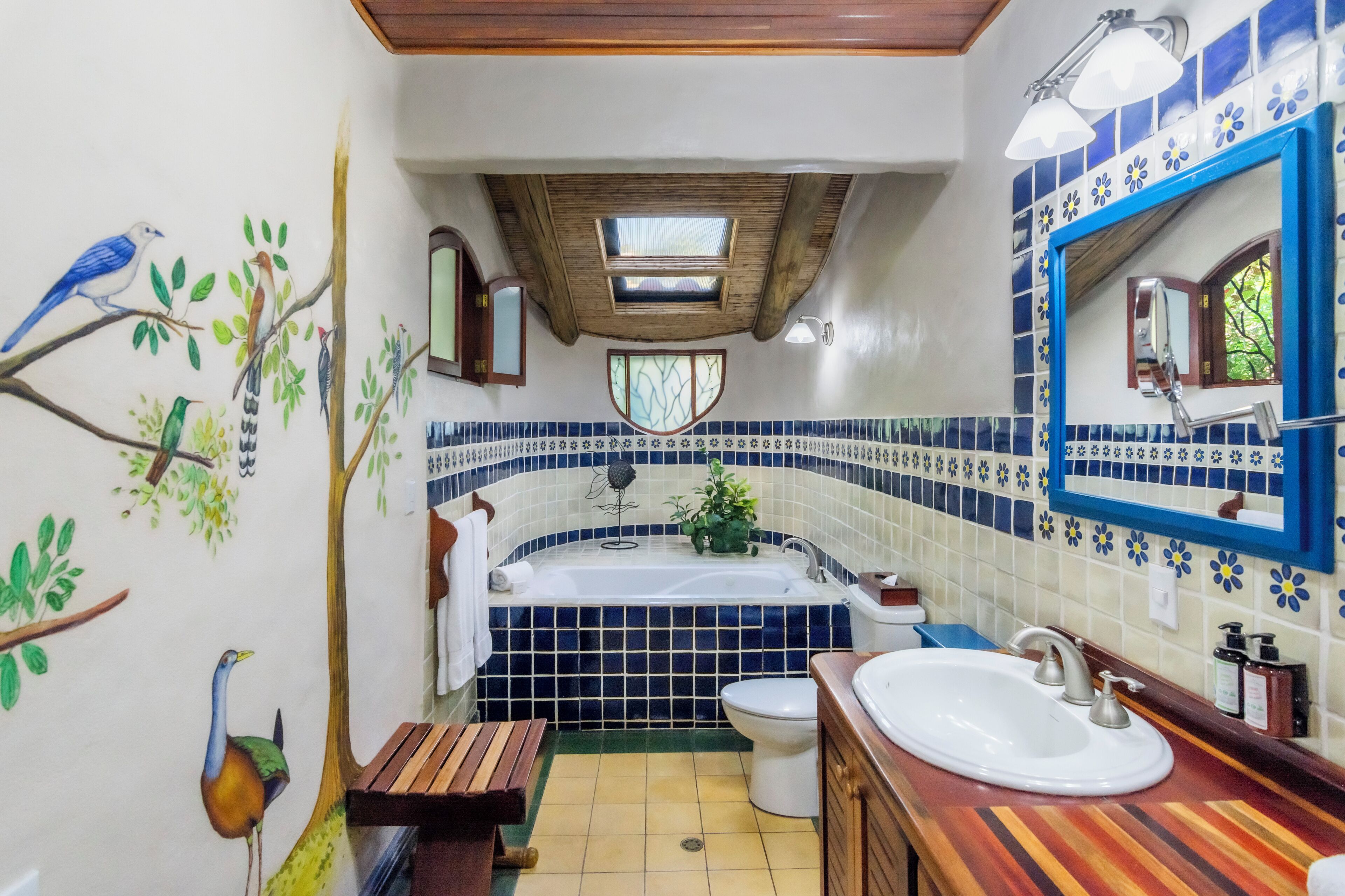 A bathroom with a bathtub, toilet, and sink.