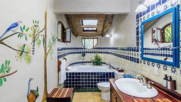 A bathroom with a bathtub, toilet, and sink.