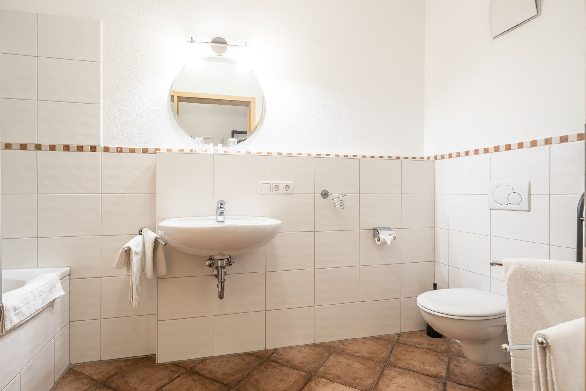 Ein Badezimmer mit Waschbecken, Toilette und Spiegel.