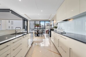 3 Bedroom 2 Bathroom - Pool View | Private kitchen | Full-size fridge, microwave, oven, stovetop - Aria Apartments (Broadbeach)