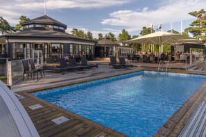 Una piscina al aire libre, tumbonas