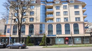 A multi-story hotel with a modern facade, large windows, and a visible restaurant named "Legends." - Legends Hotel Sofia (Sofia)