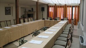 A conference room with a long table, chairs, and a speaker system. - Legends Hotel Sofia (Sofia)