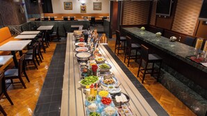 A buffet setup with various food items and a long counter. - New Osaka Hotel (Osaka)
