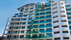 A multi-story hotel with a modern design, featuring a prominent glass facade and a sign reading "CENTURY CITY HOTEL". - Distinction Wellington Century City Hotel (Wellington)