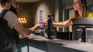 A person using a payment kiosk at a counter. - a&o Düsseldorf Hauptbahnhof (Düsseldorf)