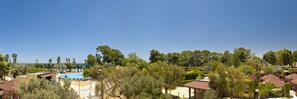 A coastal resort with a swimming pool, villas, and lush greenery. - VOI Floriana Resort (Simeri-Crichi)