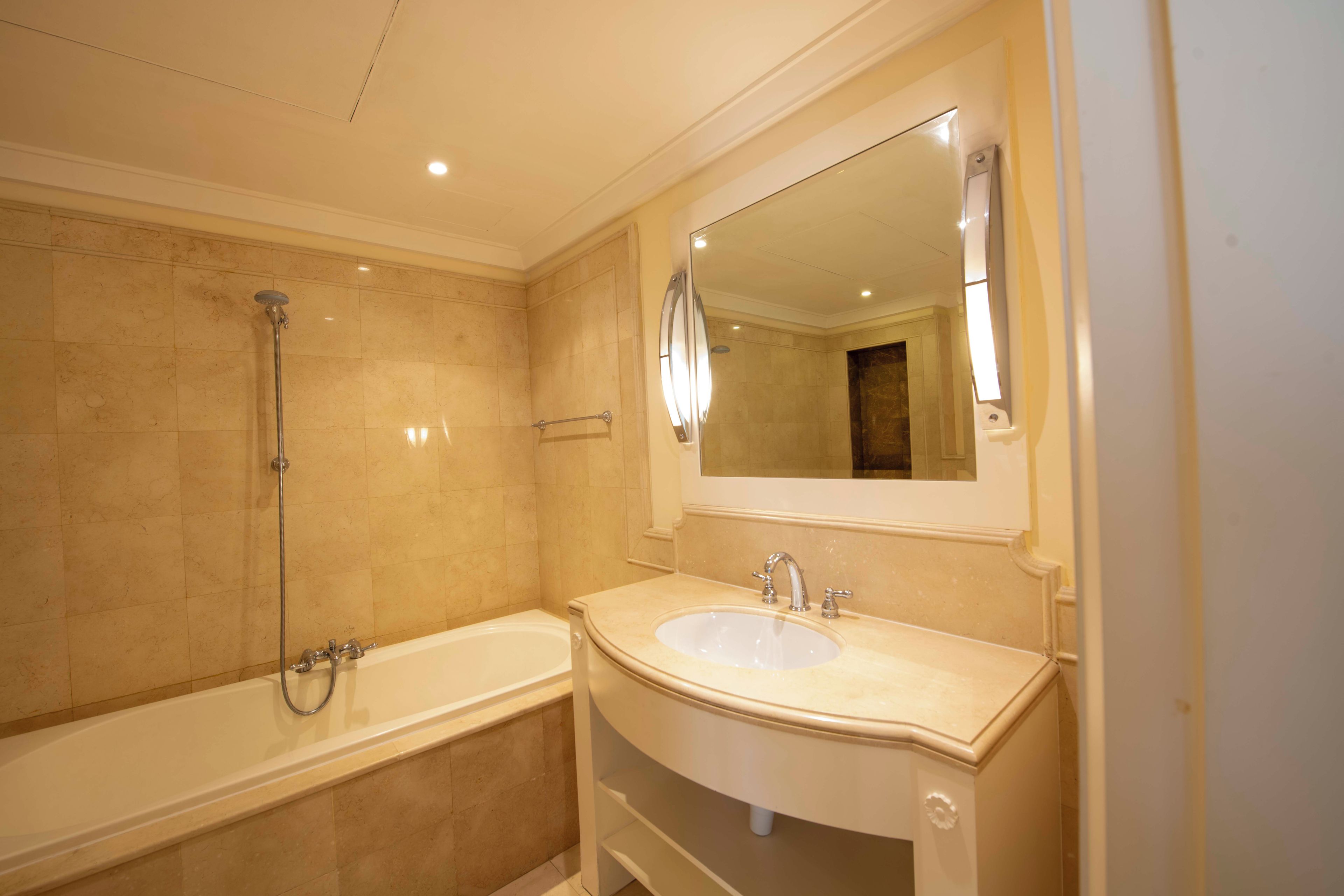 A bathroom with a bathtub, a sink, and a shower.