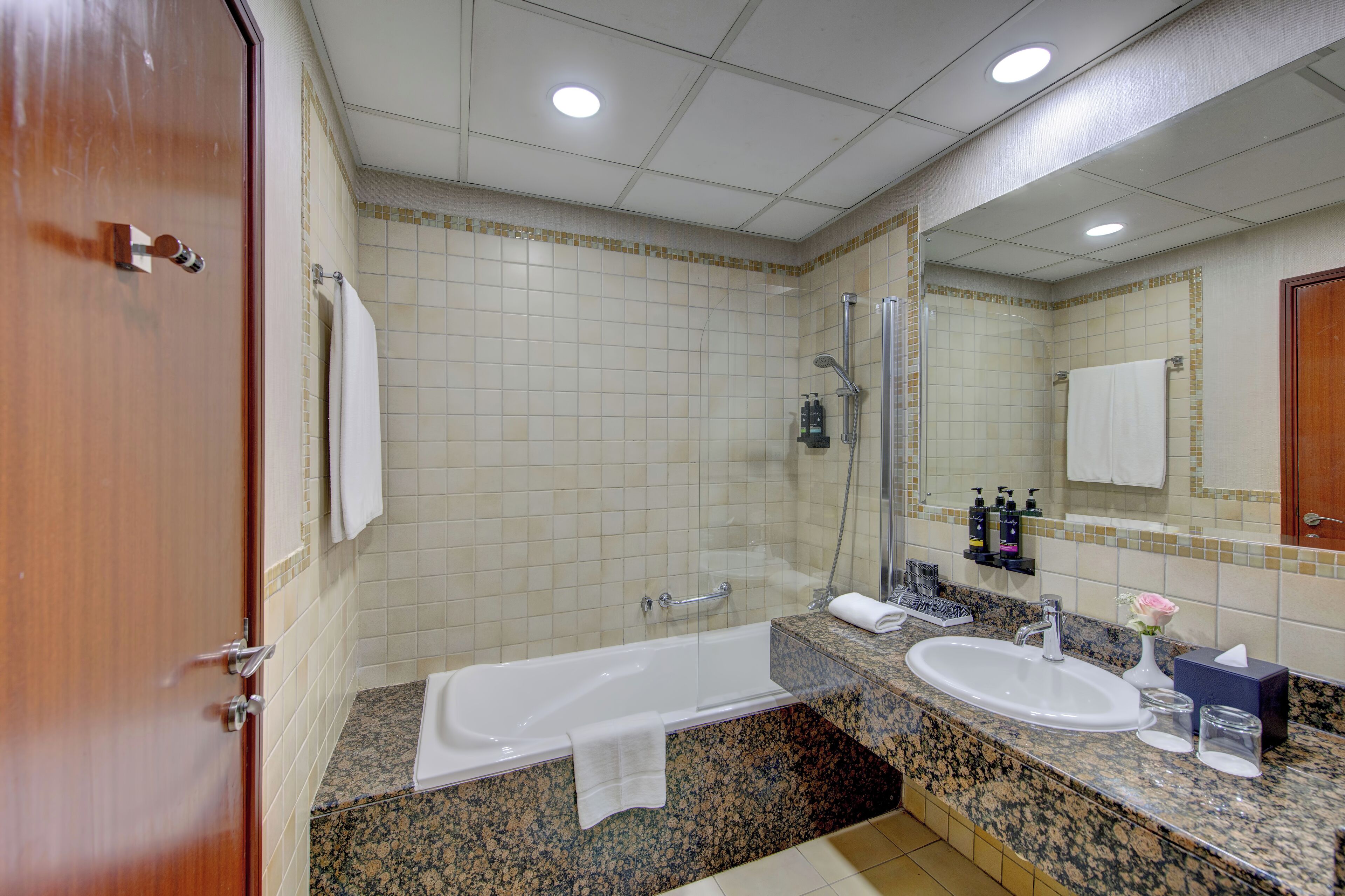 A bathroom with a bathtub, a sink, and a shower.