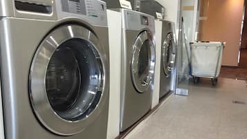 A row of LG front-loading washing machines in a commercial setting.