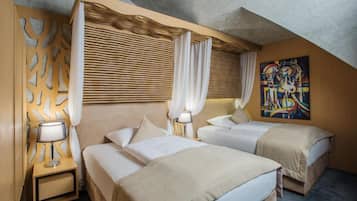 Una camera d'albergo con due letti, un grande quadro astratto e un design di soffitto originale.