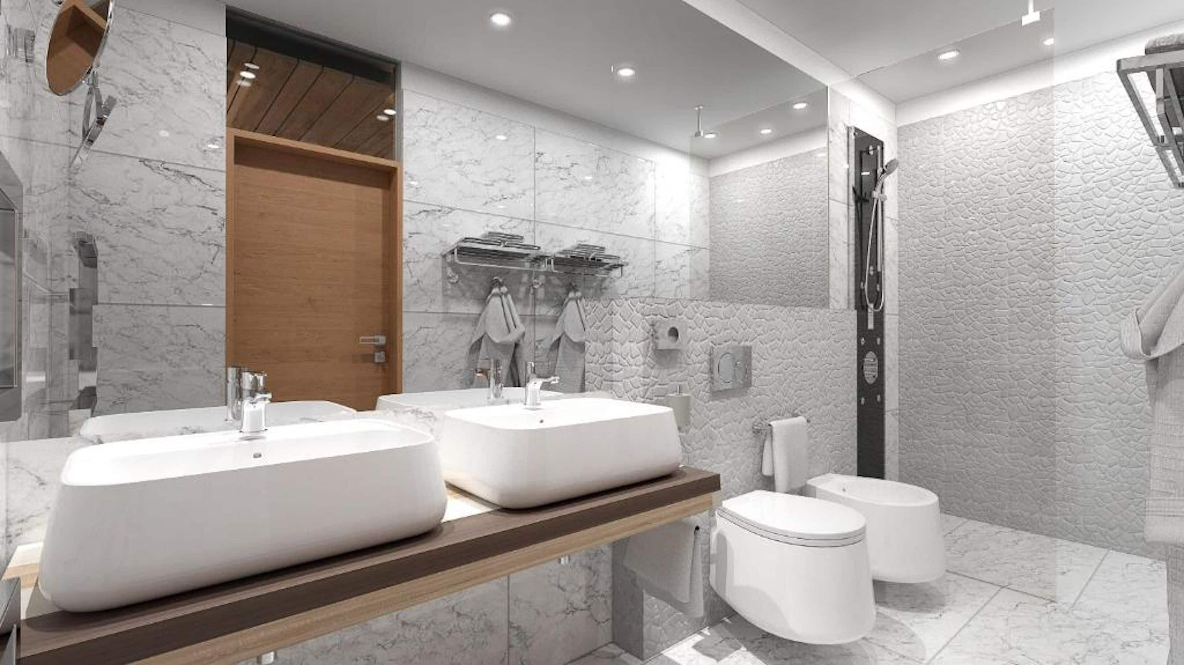 Un baño moderno con dos lavamanos grandes de color blanco, un mueble de tocador de madera, un box de ducha de vidrio y paredes de mármol.