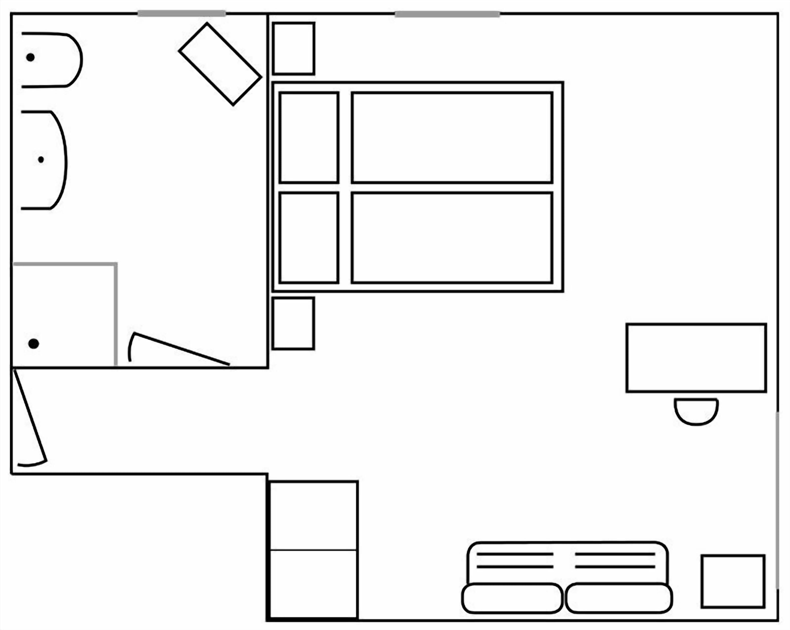 Distribución de una habitación de hotel con cama, escritorio, silla, televisor y baño.