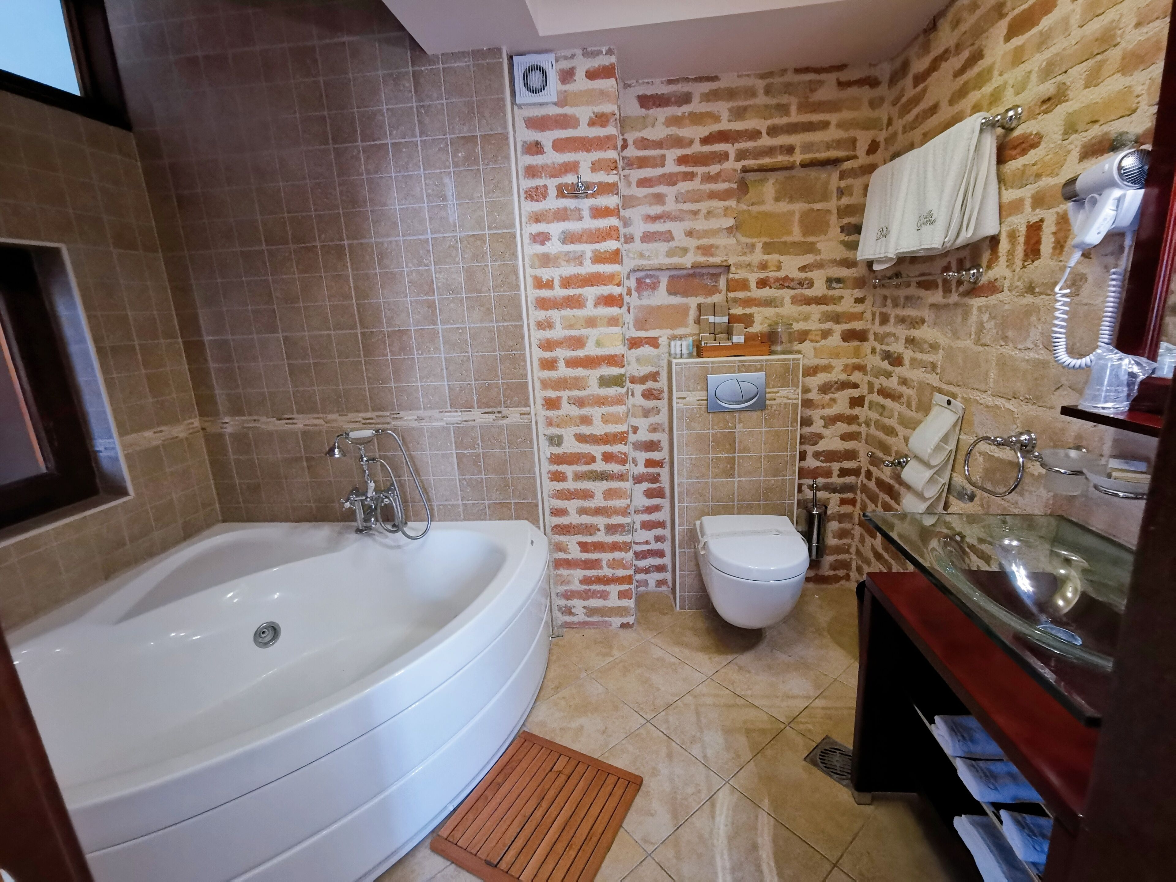 A bathroom with a bathtub, a toilet, and a sink.