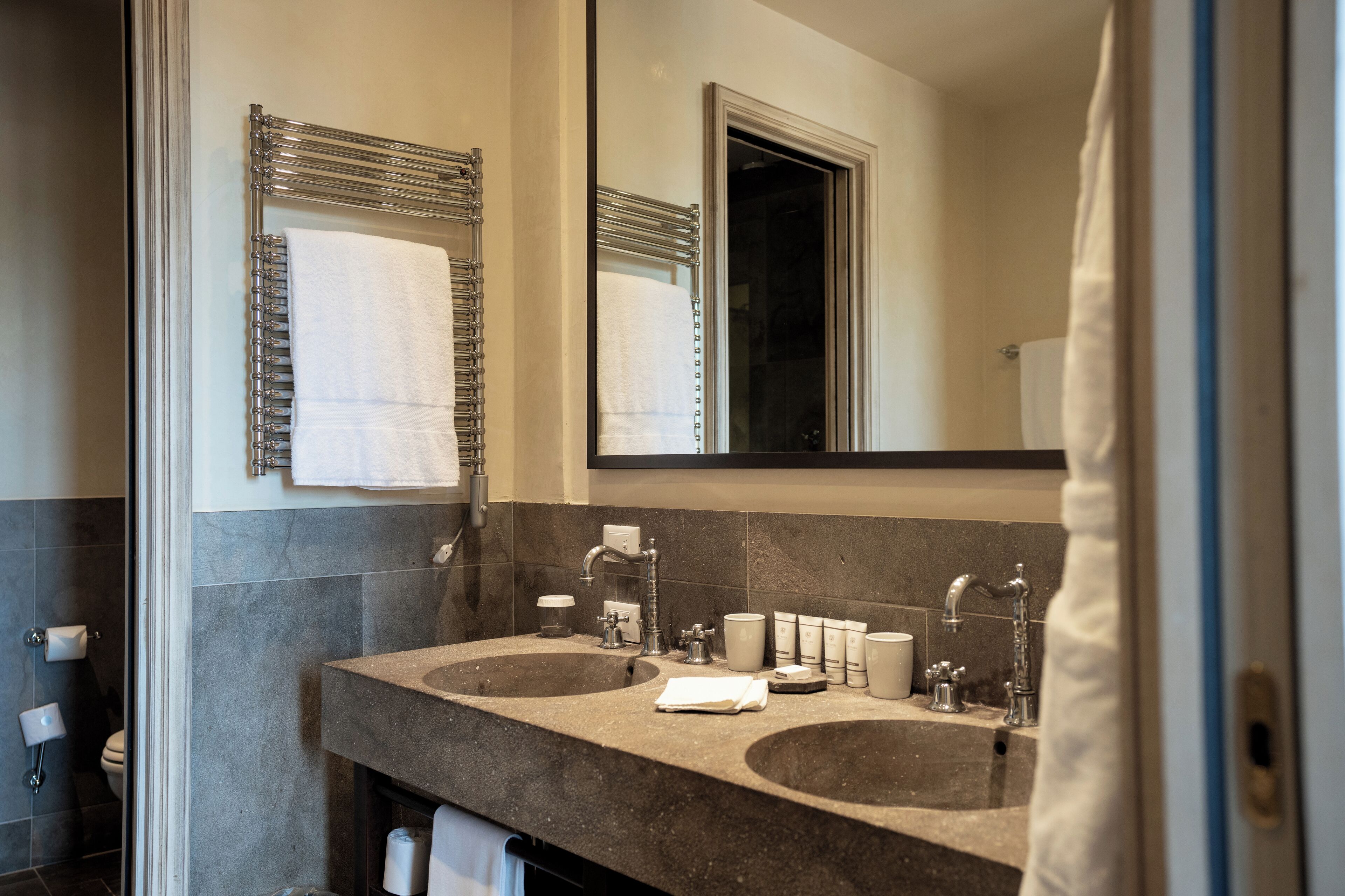 A bathroom with two sinks, a mirror, and a shower curtain.