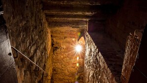 A stone staircase with candles and a sign reading "CANTINA". - Castel Monastero - The Leading Hotels of the World (Castelnuovo Berardenga)