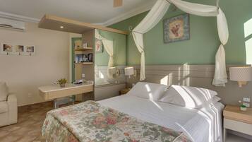 A bedroom with a bed, a desk, a chair, a nightstand, and a ceiling fan.