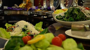 A buffet with various salads and dishes.