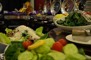 A buffet with various salads and dishes.