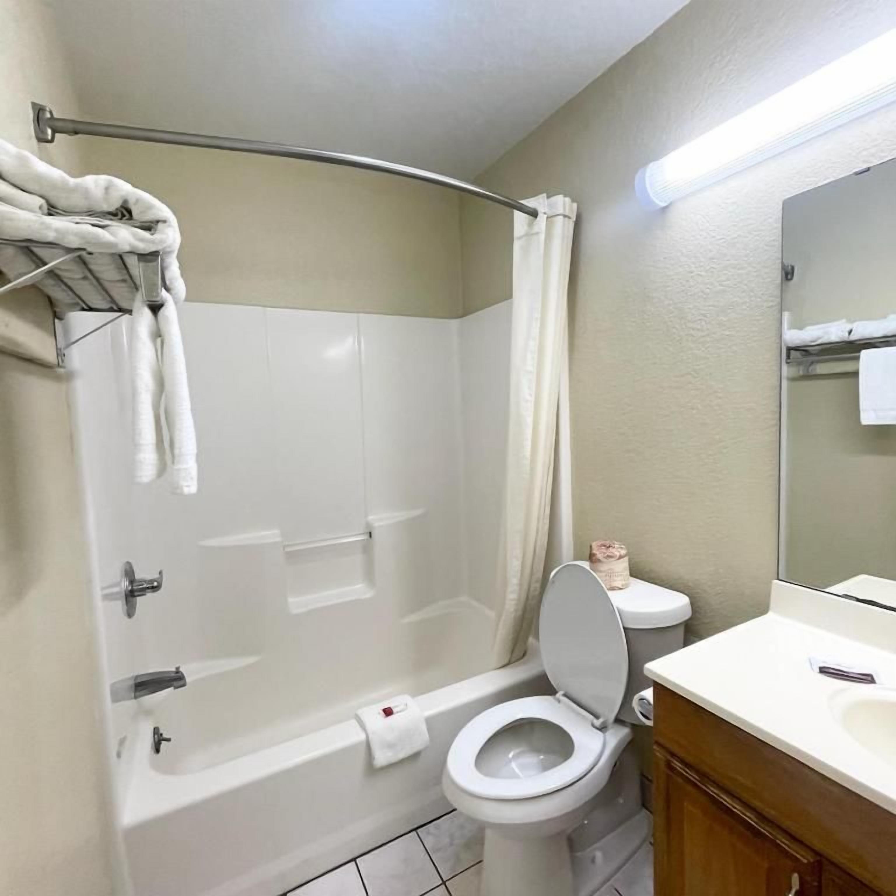 Un baño con bañera, inodoro y lavabo.