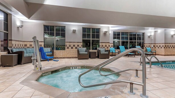 An indoor swimming pool with a no diving sign, lounge chairs, and a tiled floor. - Residence Inn By Marriott Columbus (Columbus)