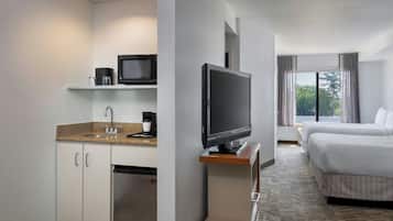 Premium bedding, desk, laptop workspace, blackout drapes