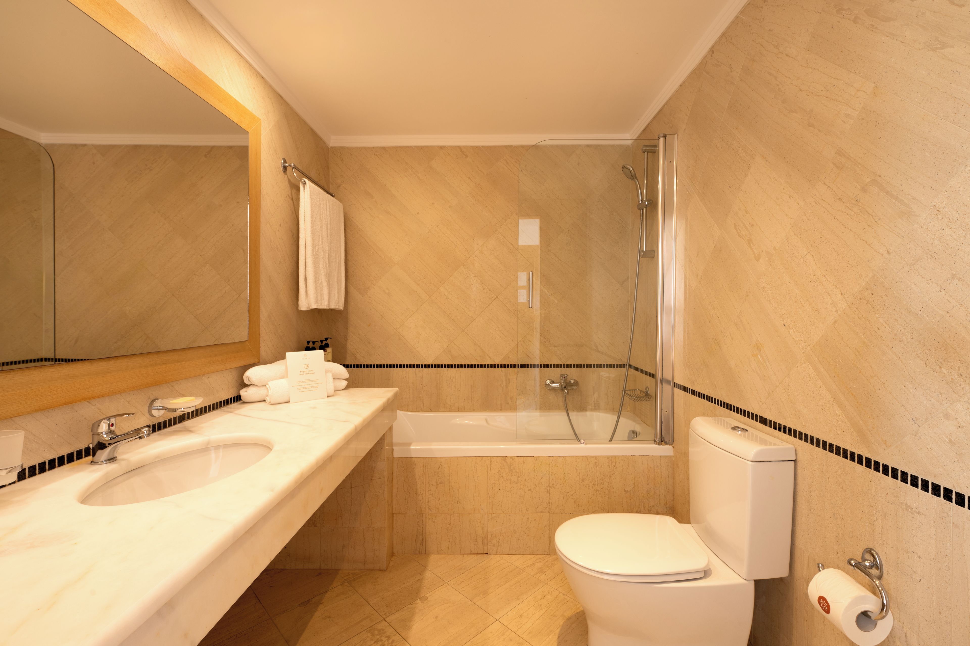 Un baño con bañera, inodoro y lavamanos.