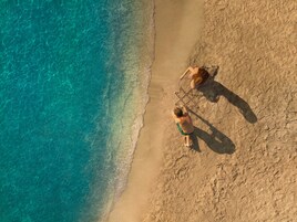 On the beach, sun loungers, beach umbrellas, beach towels