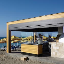 Enjoy a seaside dining experience with ocean views from our open-air bar, featuring a countertop and comfortable seating.