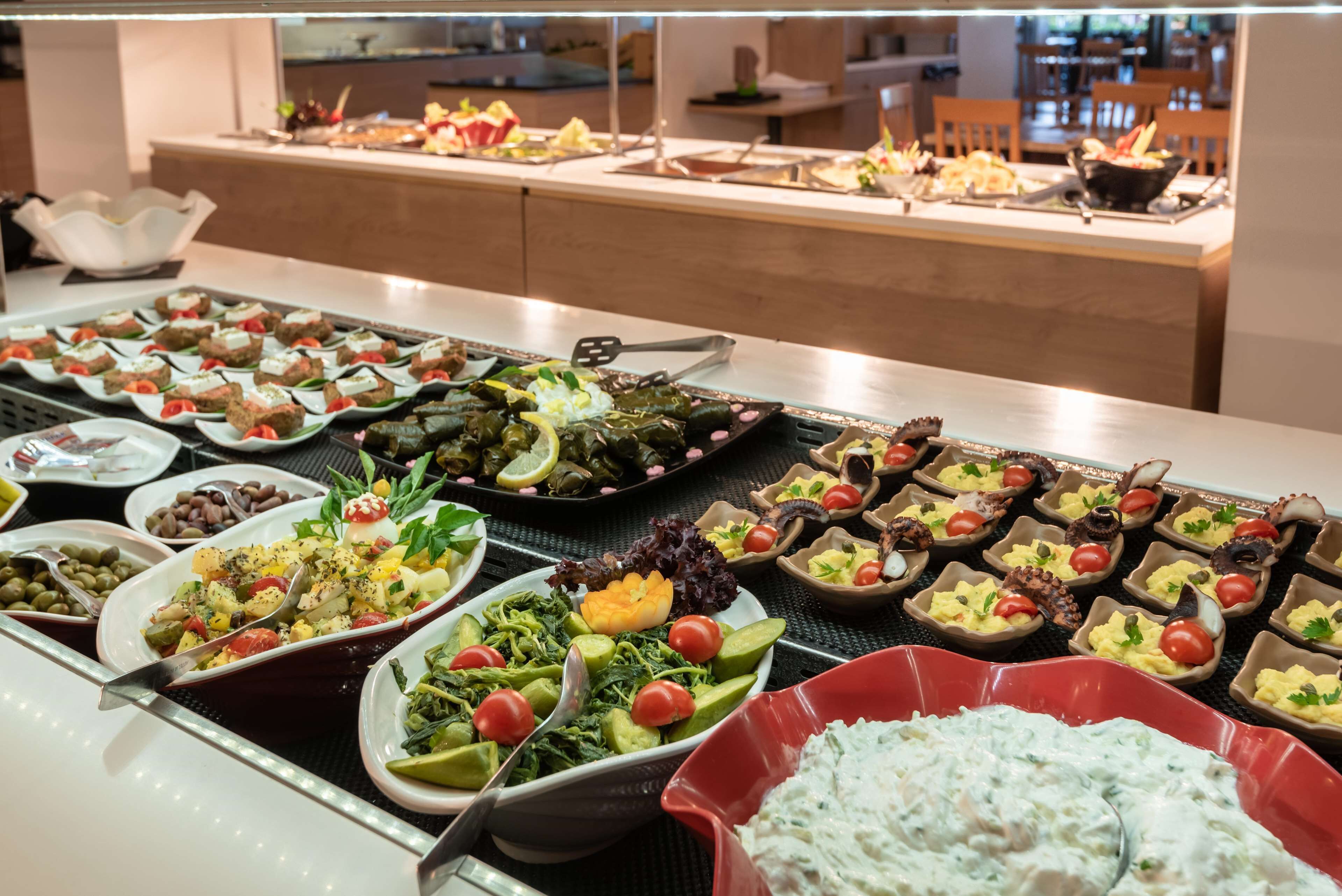 A buffet with various dishes including salads, rice, and seafood.
