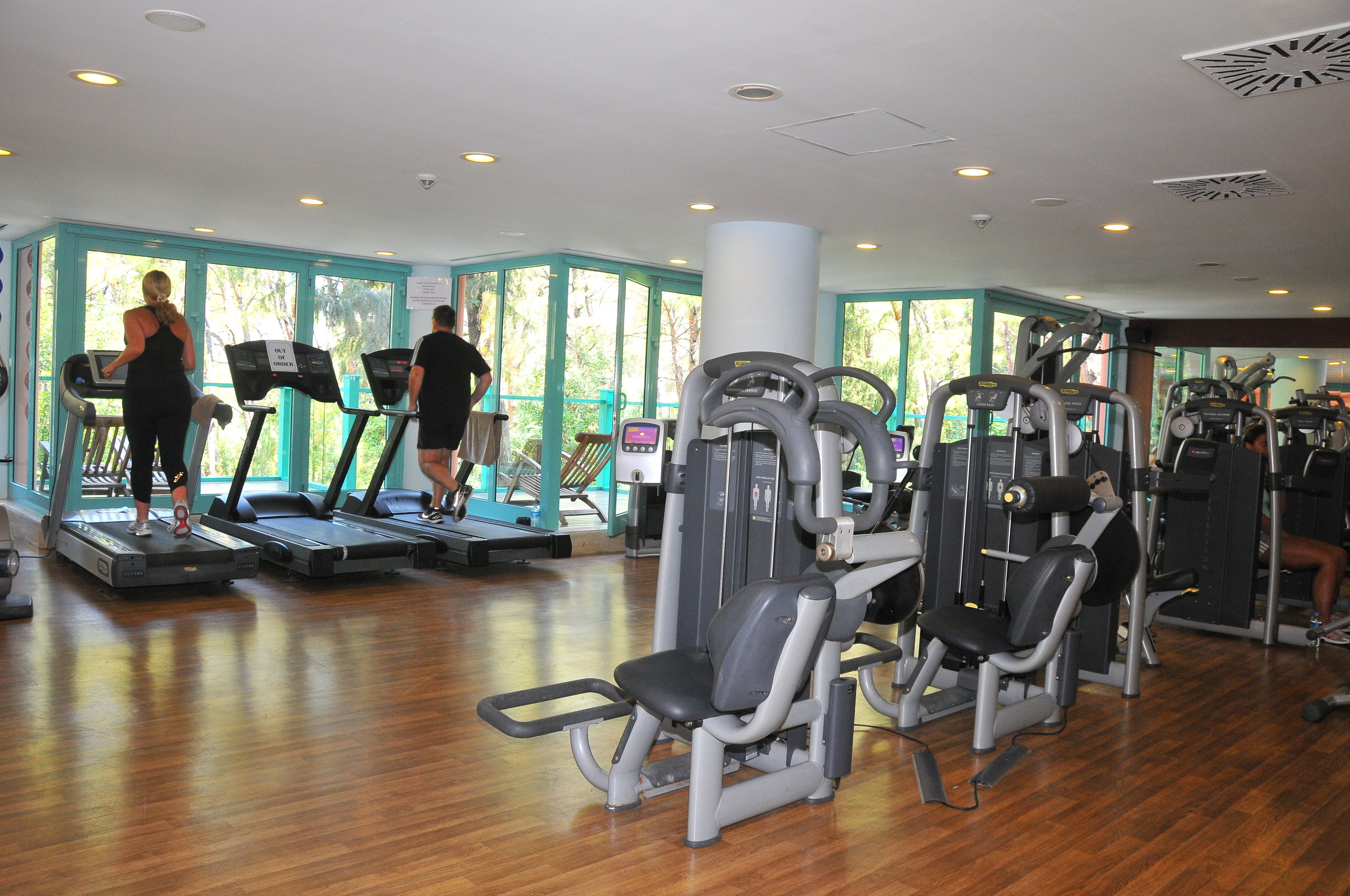 A gym with treadmills, elliptical machines, and weight equipment.