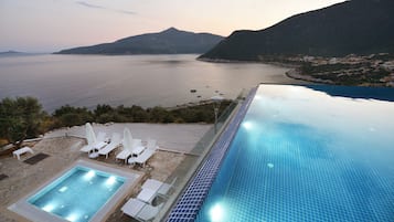 Seasonal outdoor pool, open 10:00 AM to 7:00 PM, pool umbrellas