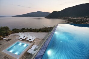 Seasonal outdoor pool, open 10:00 AM to 7:00 PM, pool umbrellas